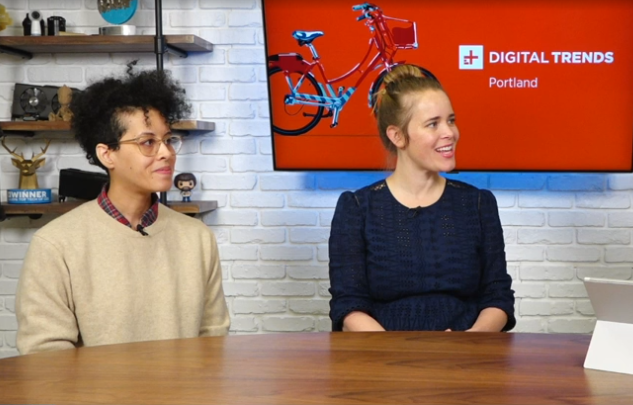 Dawn Mott and Elizabeth Stock sit in front of a screen giving an interview on Digital Trends internet television.